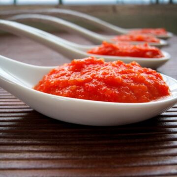 home made west indian pepper sauce in a white spoon