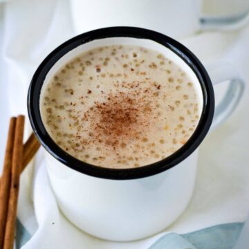 This is a white mug with sago porridge inside.