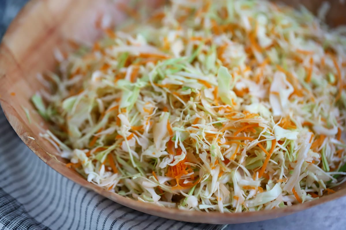 Mixing bowl with shredded cabbage and carrots without dressing.