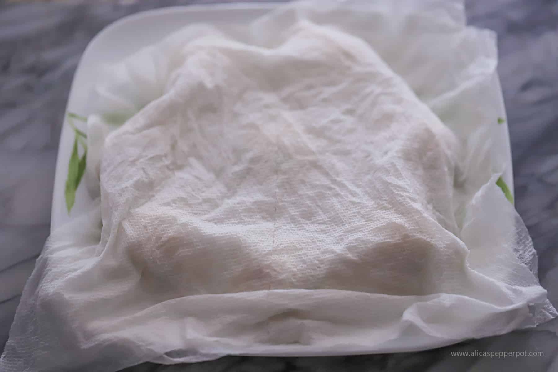 Dough balls covered with damp paper towel