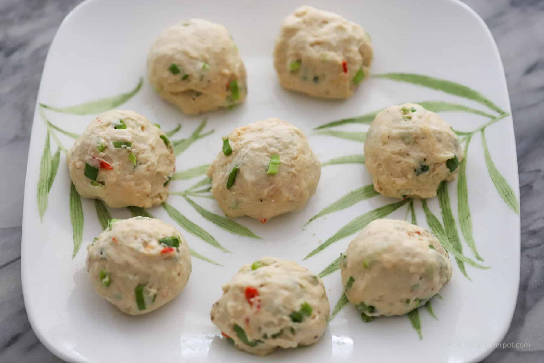 This is an image of a the dough ball on a greased plate.