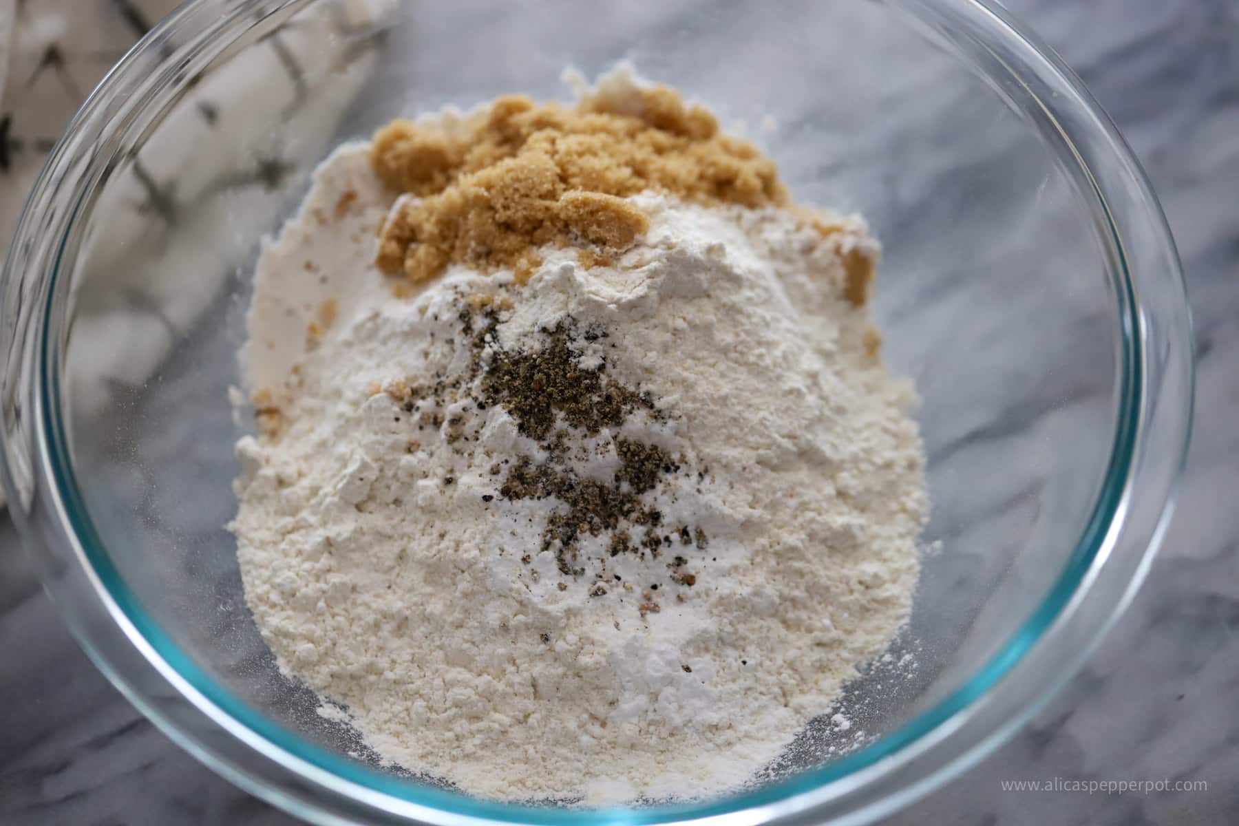 dry seasonings for flour mixture in mixing bowl.