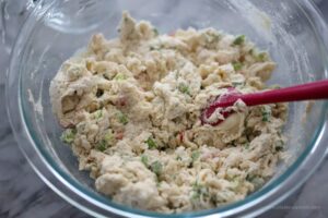 Dough for scallion fry bake being mixed using a pink spatula