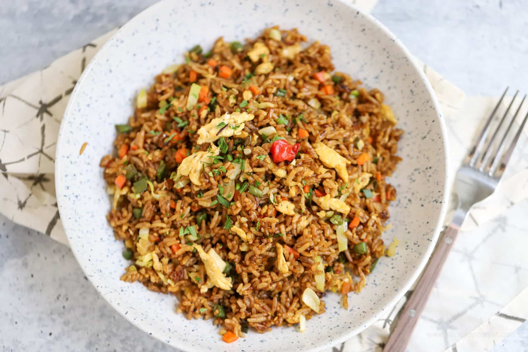 Small batch fried rice in serving dish with fork on side of plate.