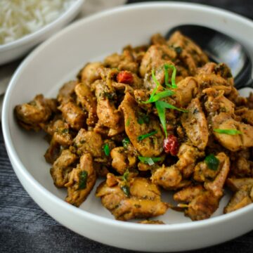 This is a photo of small pieces of black pepper chicken cut up and in a white bowl.