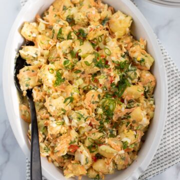 cassava salad in a white serving bowl